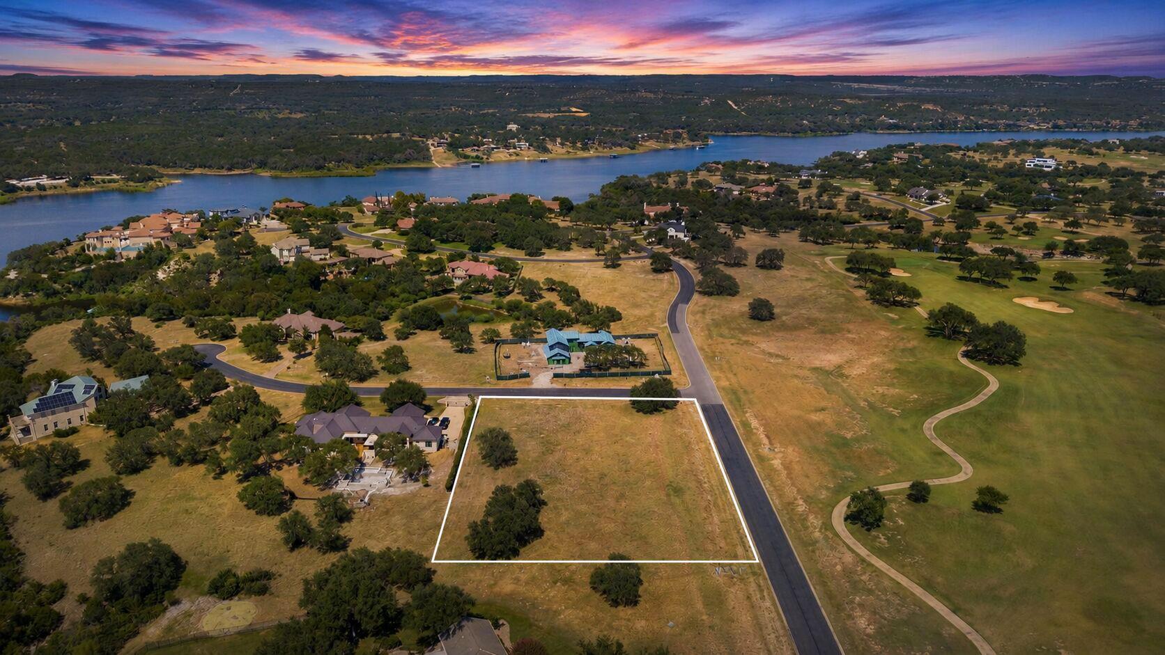 Perched above a scenic lake and golf course, this