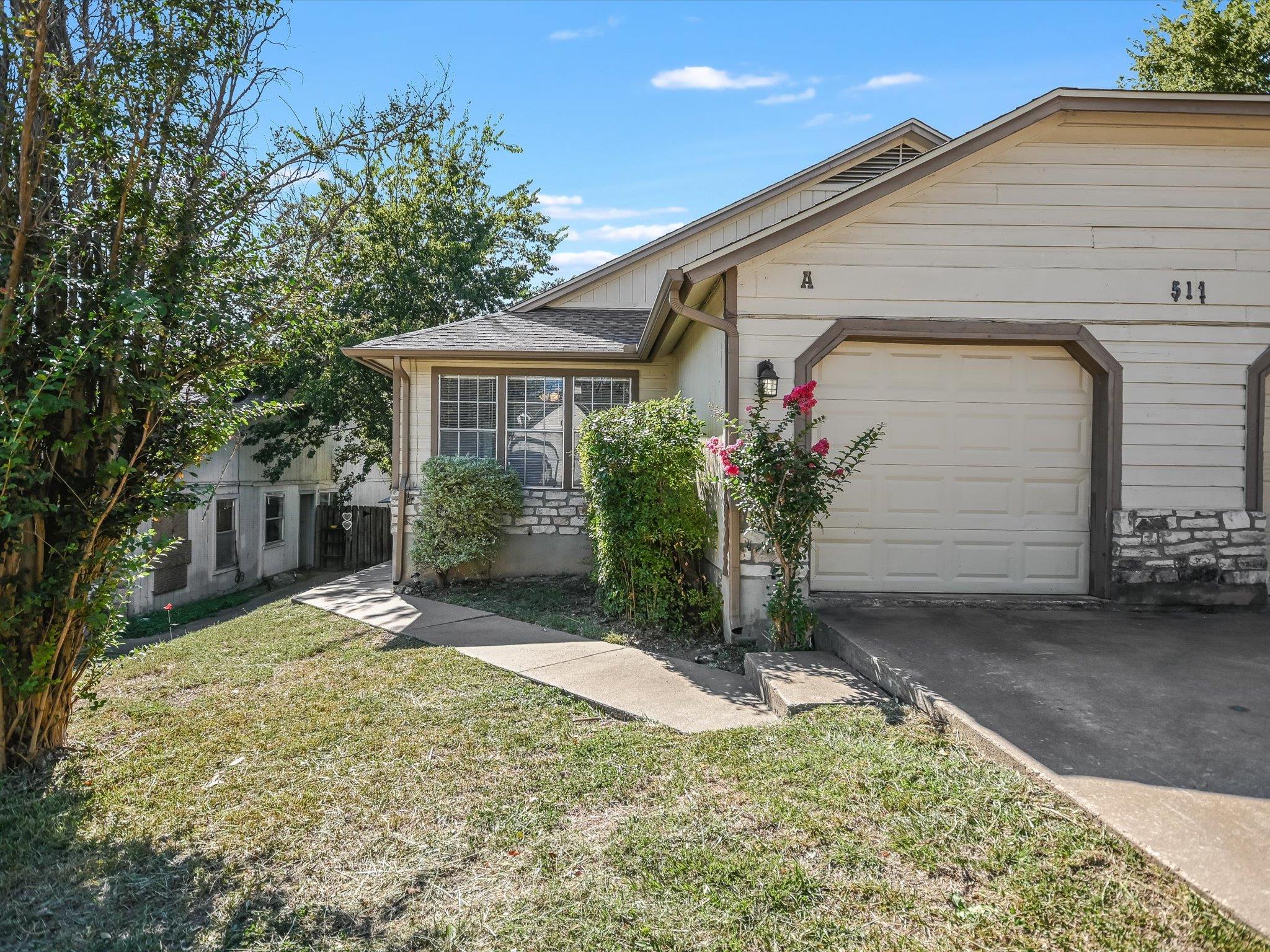 A welcoming facade offers an attached garage and 