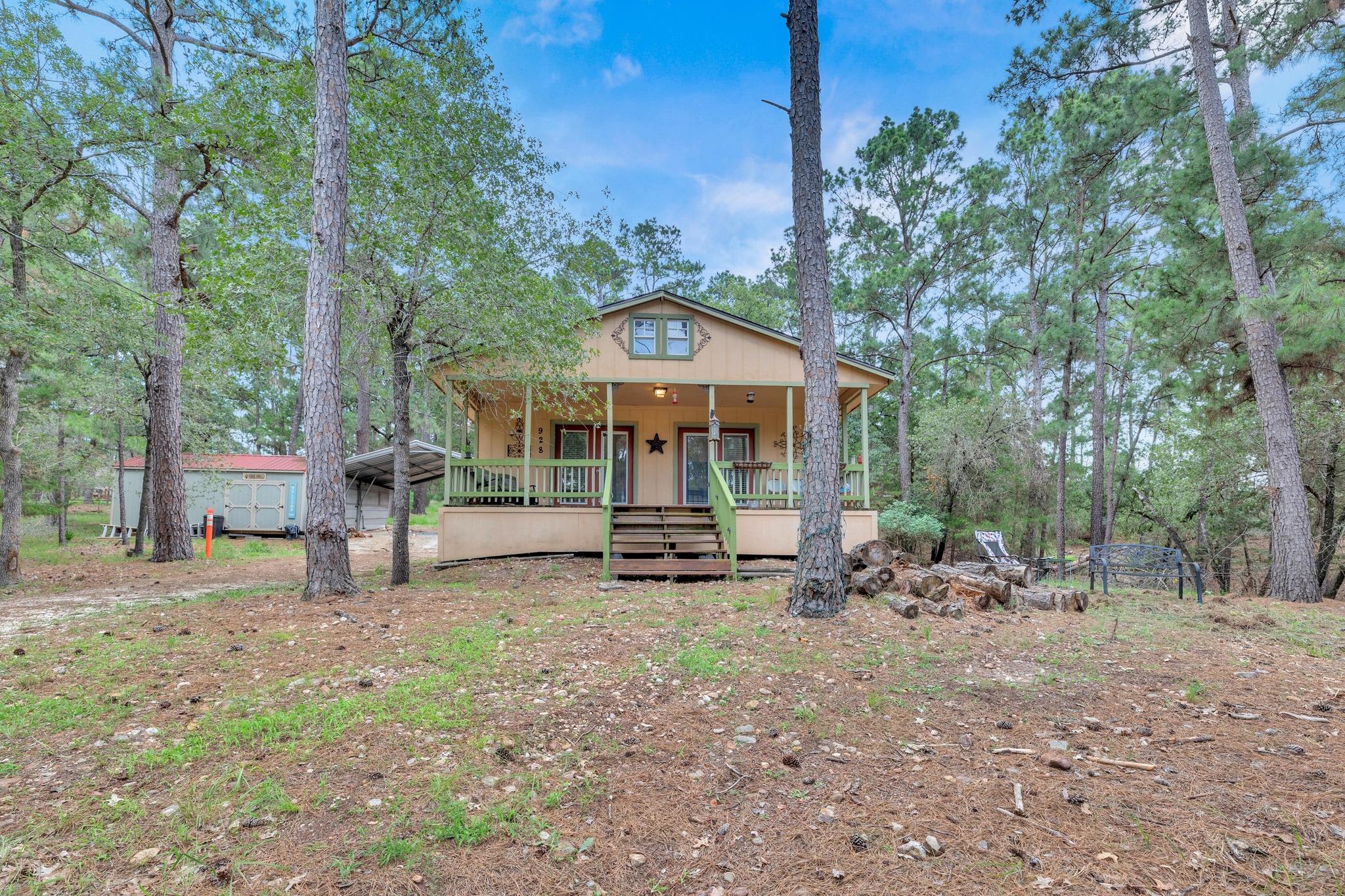 A charming wood-sided cottage, nestled among matu