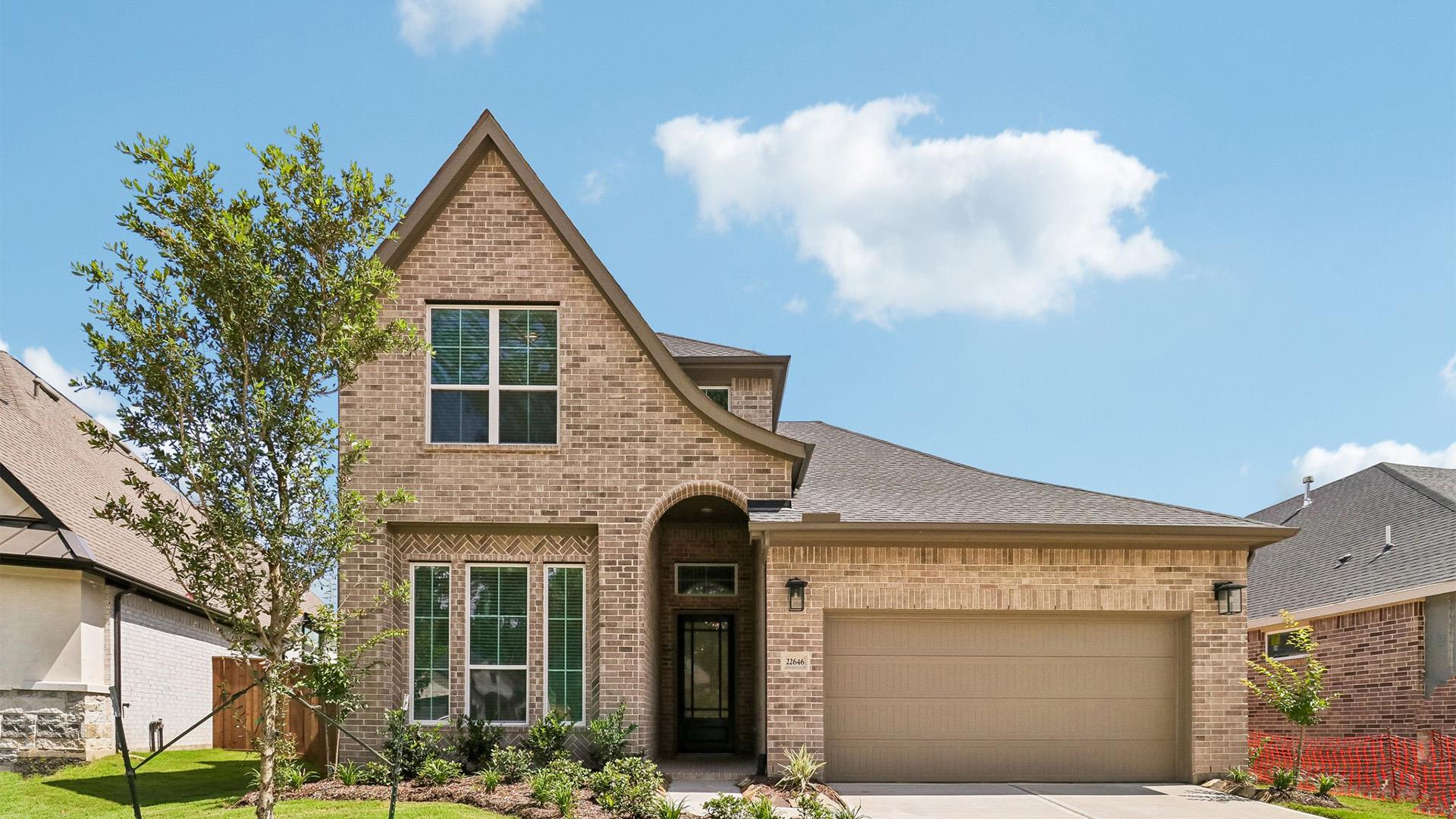 A classic brick facade and arched entry define th
