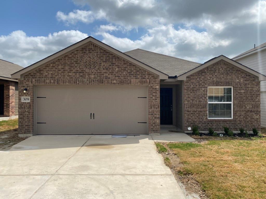 A classic brick exterior and attached garage welc