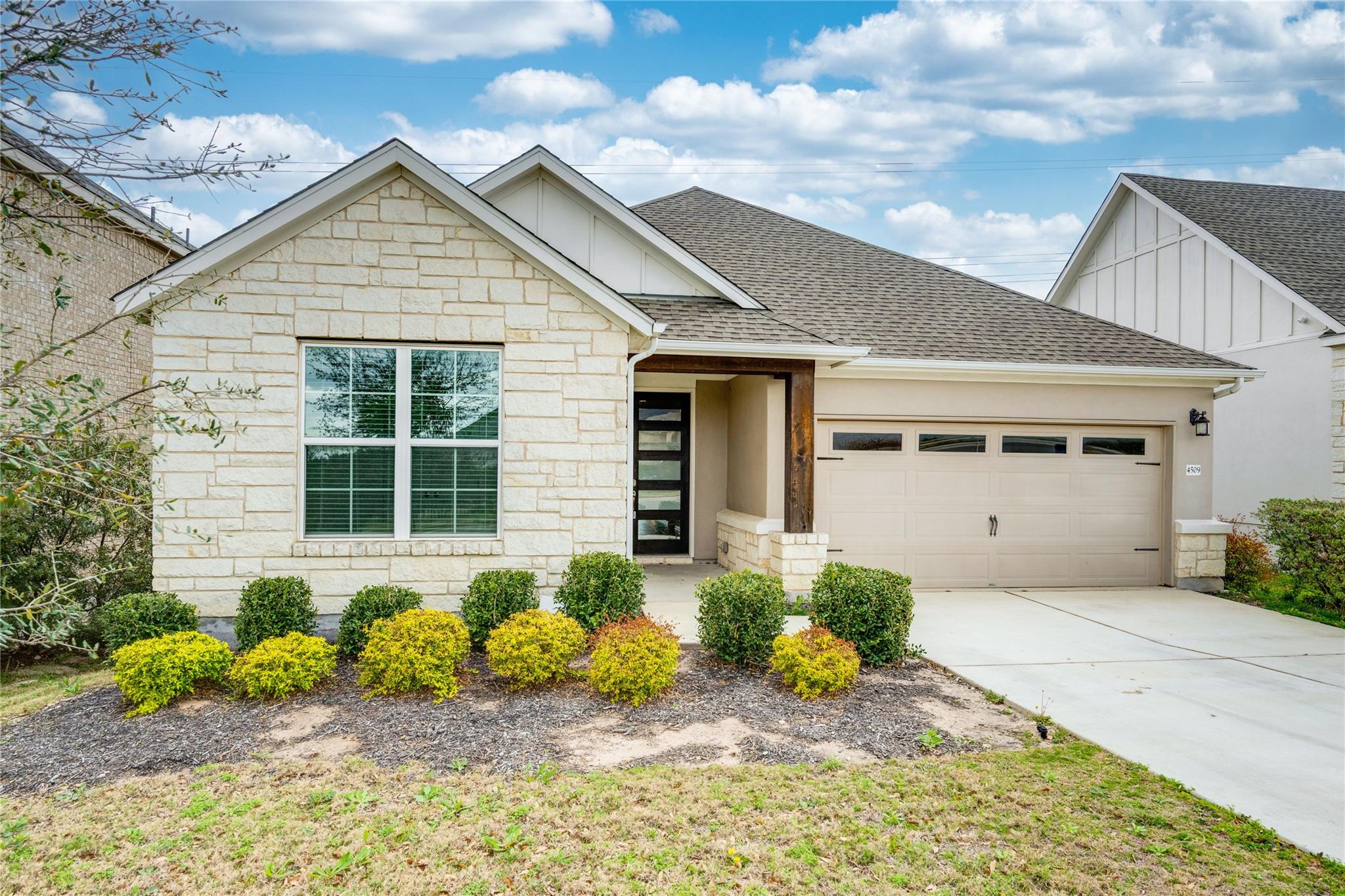 A cream-colored brick facade and contrasting dark