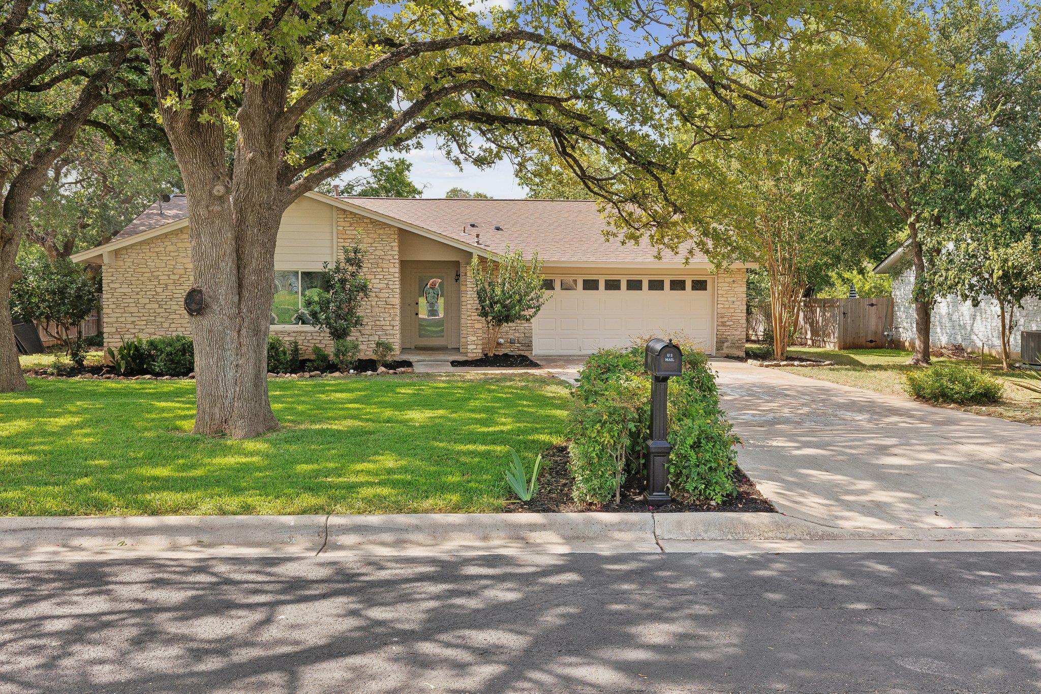 A welcoming stone-front residence with an attache