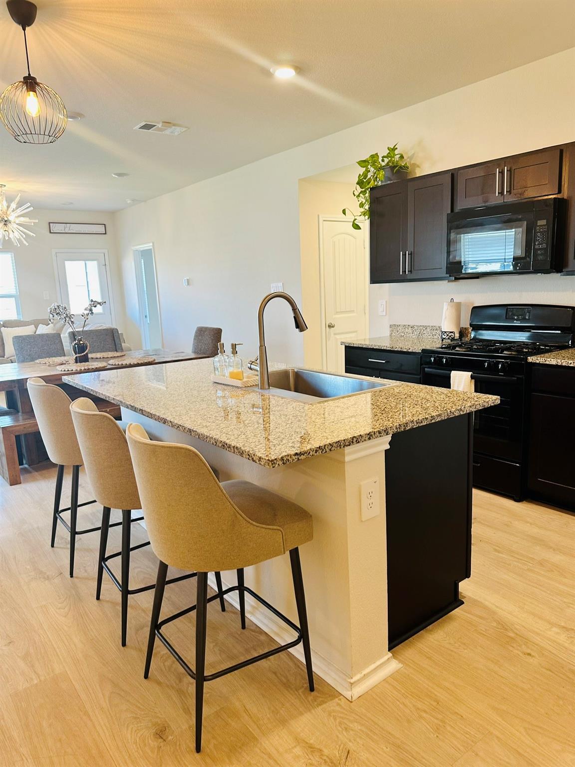 A well-appointed kitchen island with a sink provi