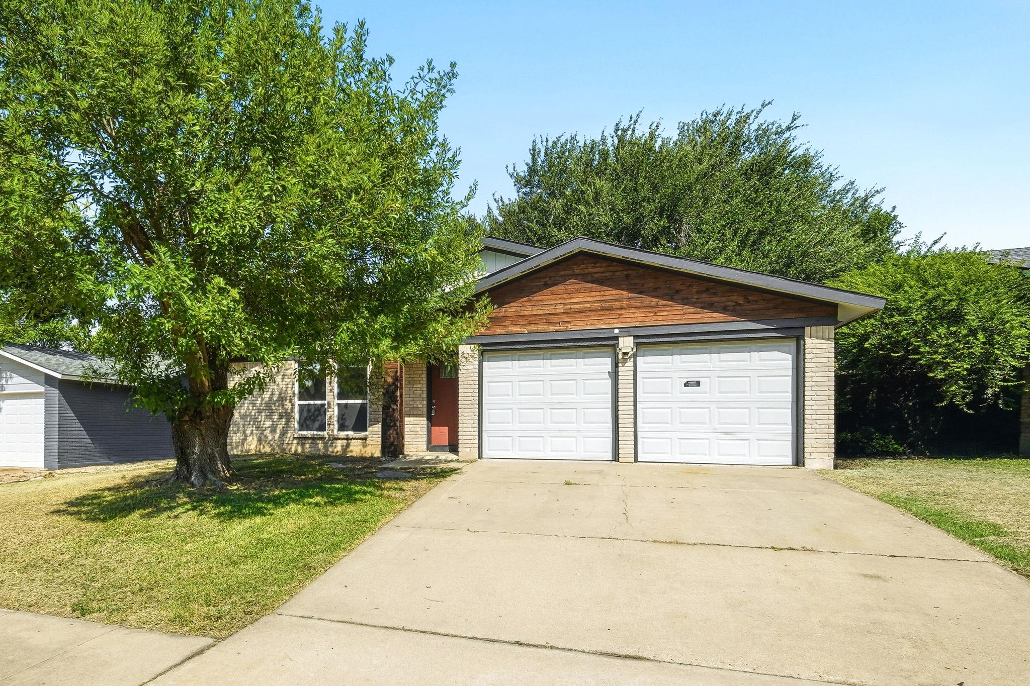 Well-maintained brick and wood facade home offers