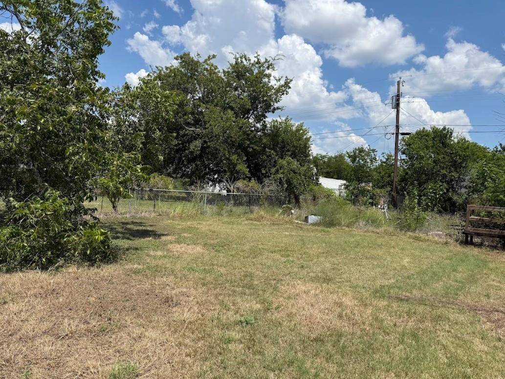 A generous, open yard offers ample space for outd