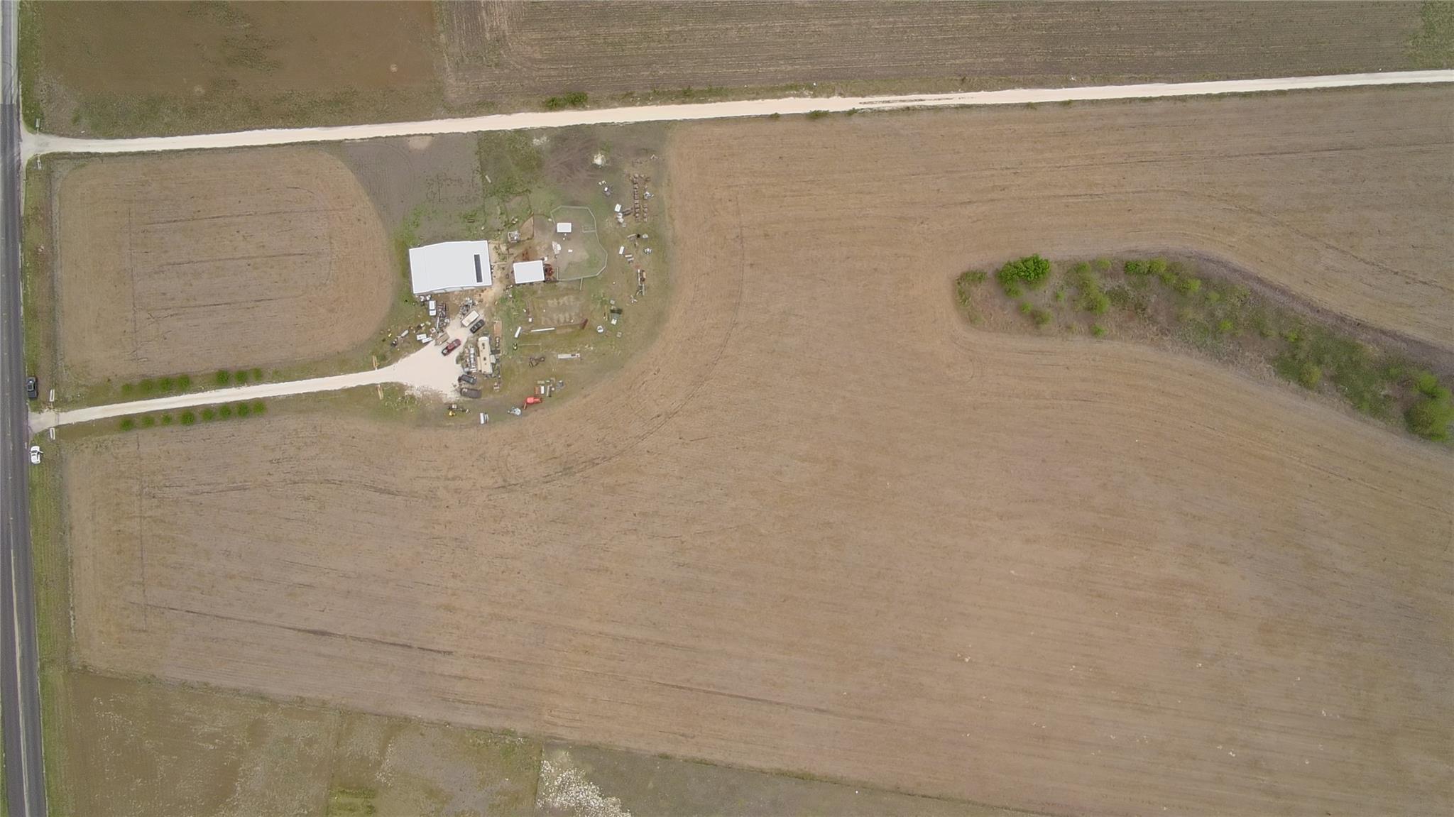 Aerial view reveals vast acreage surrounding an e