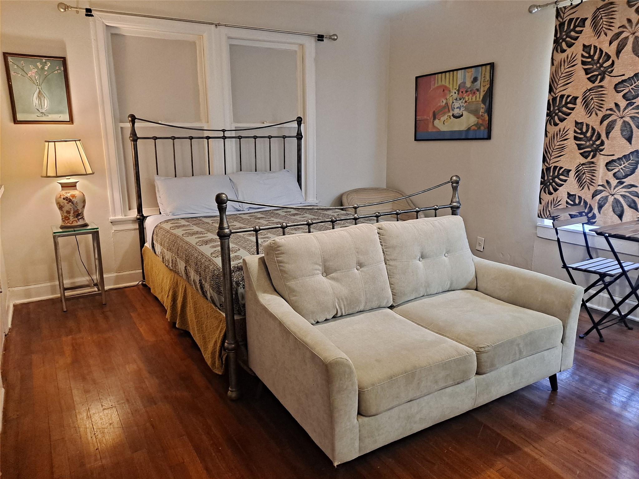 Rich hardwood floors anchor this inviting bedroom