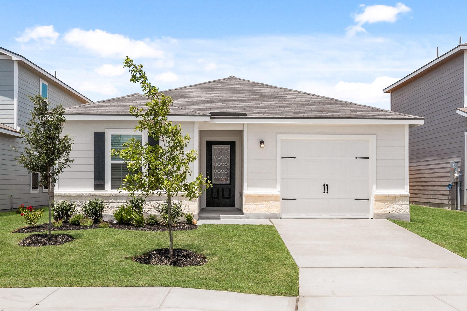 Single story home with roof with shingles, a gara