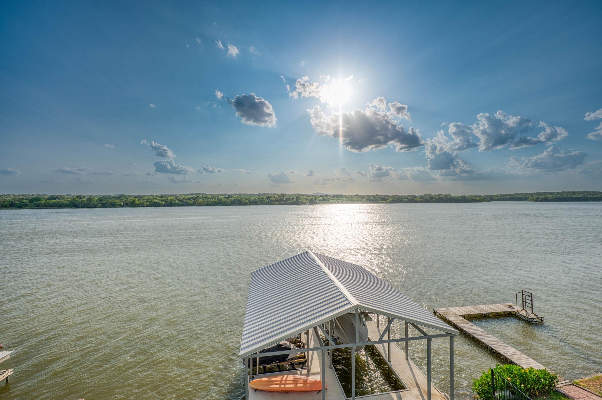 A boat dock with a covered slip extends into a wi