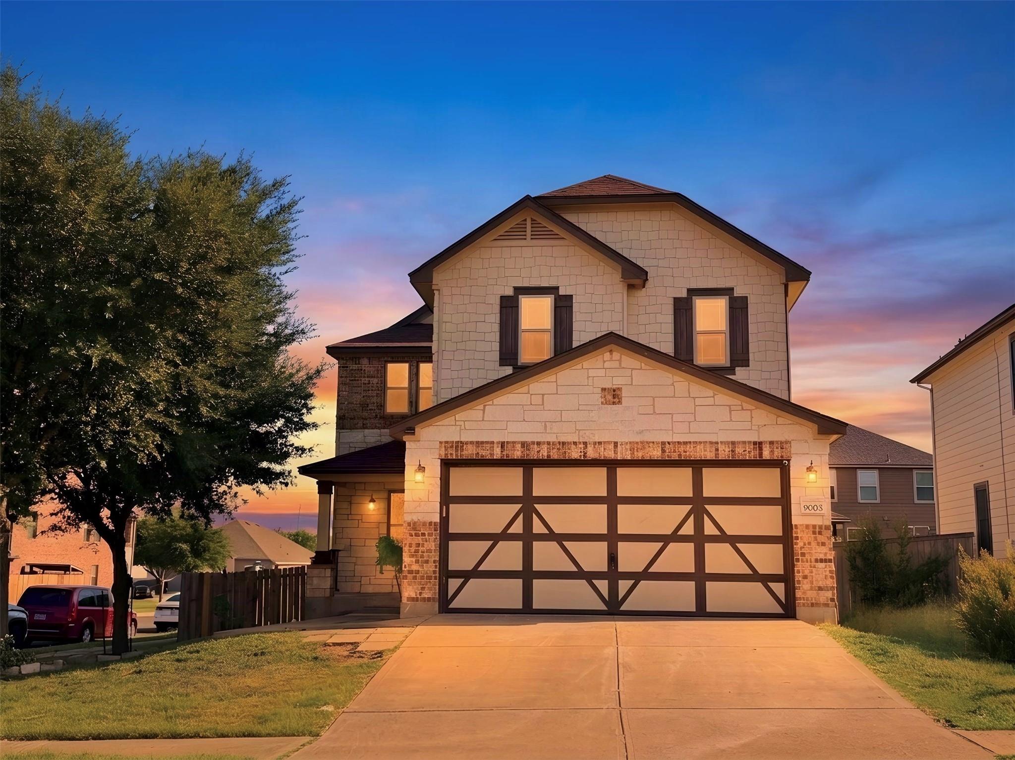A charming two-story home with a prominent garage