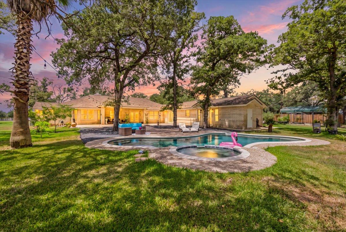 An inviting backyard oasis offers a sparkling poo