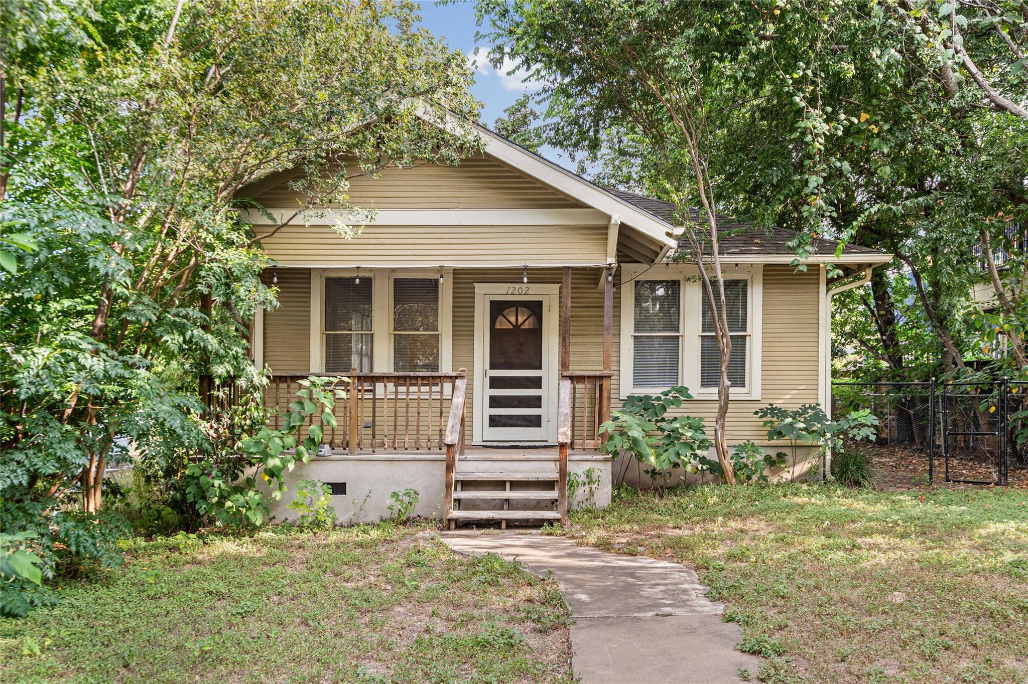 A welcoming front porch leads to this charming bu