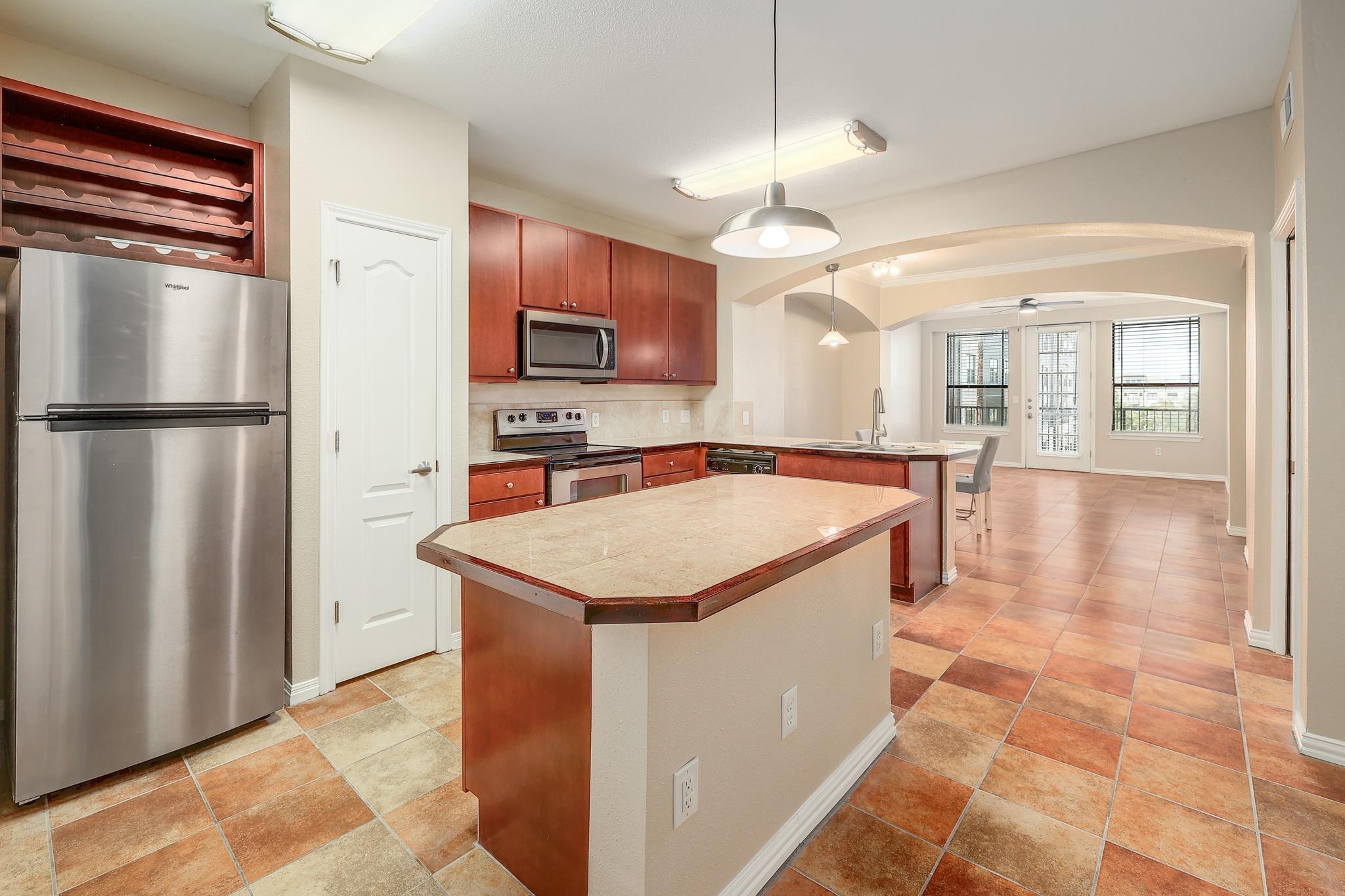 A well-appointed kitchen features a central islan