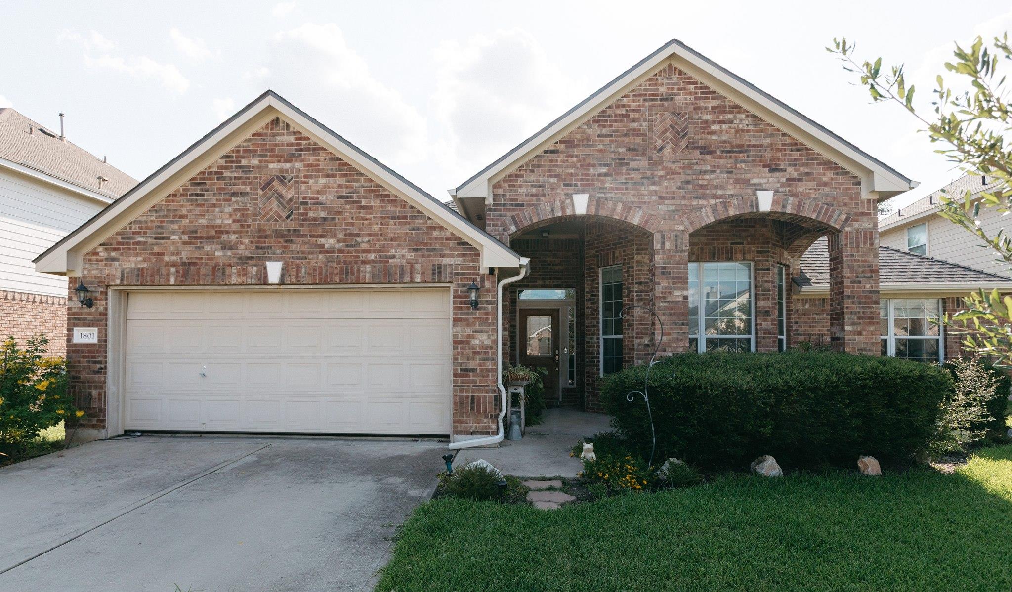 Brick facade with arched entryways and an attache