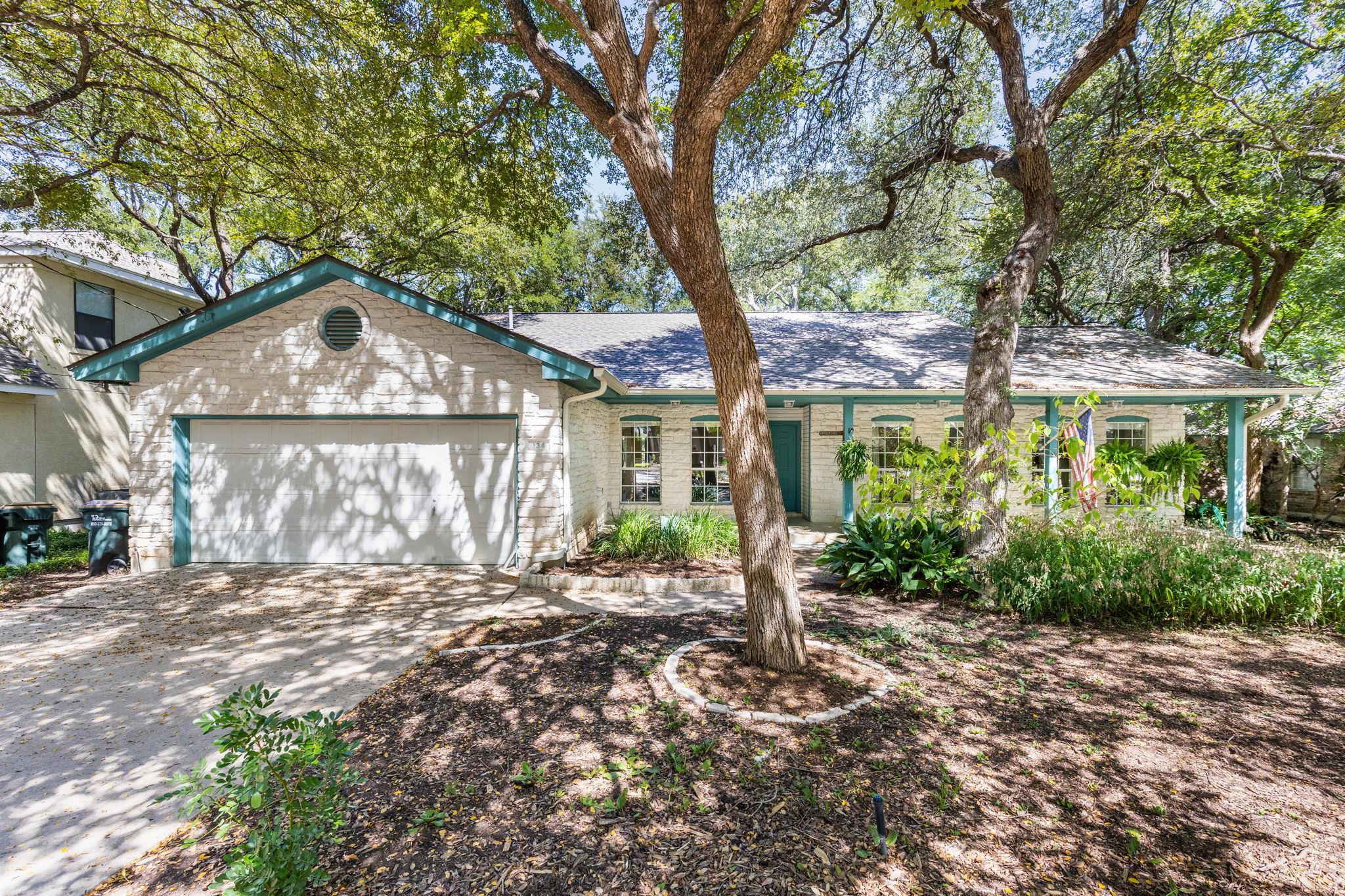Mature trees shade this classic single-story home