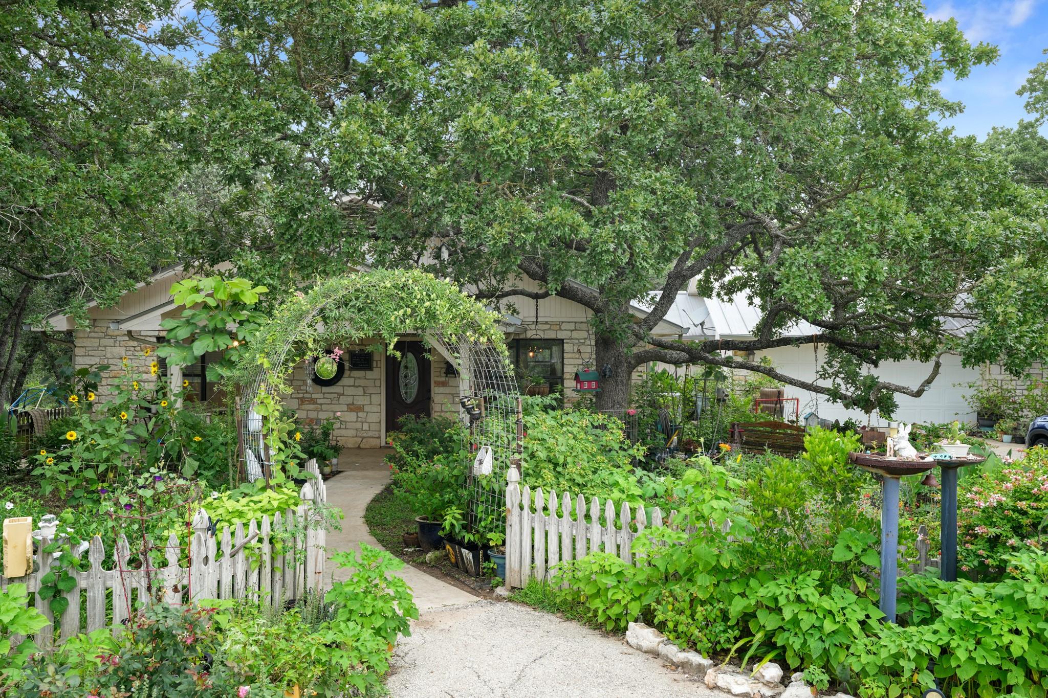 A charming stone cottage is nestled among abundan