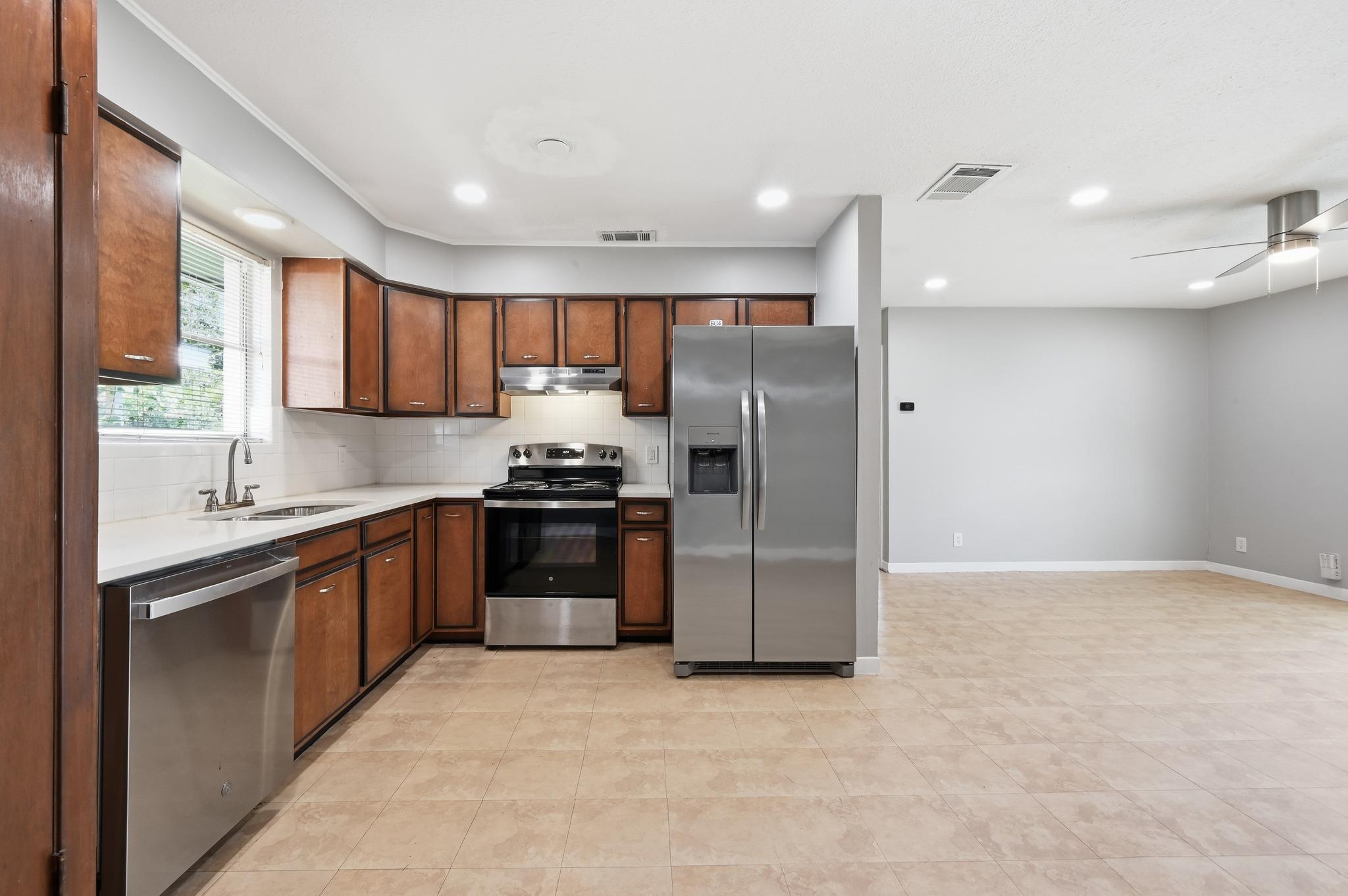 A well-appointed kitchen features rich cabinetry,