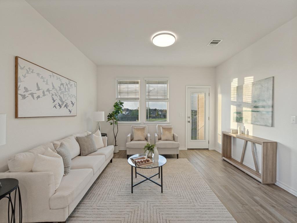 A glass door and multiple windows invite natural 