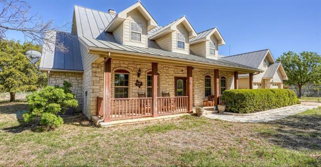 A stone-clad home features a welcoming front porc
