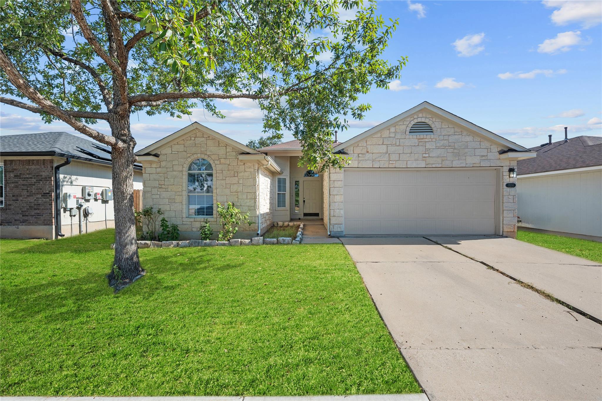 An arched window and textured stone siding define