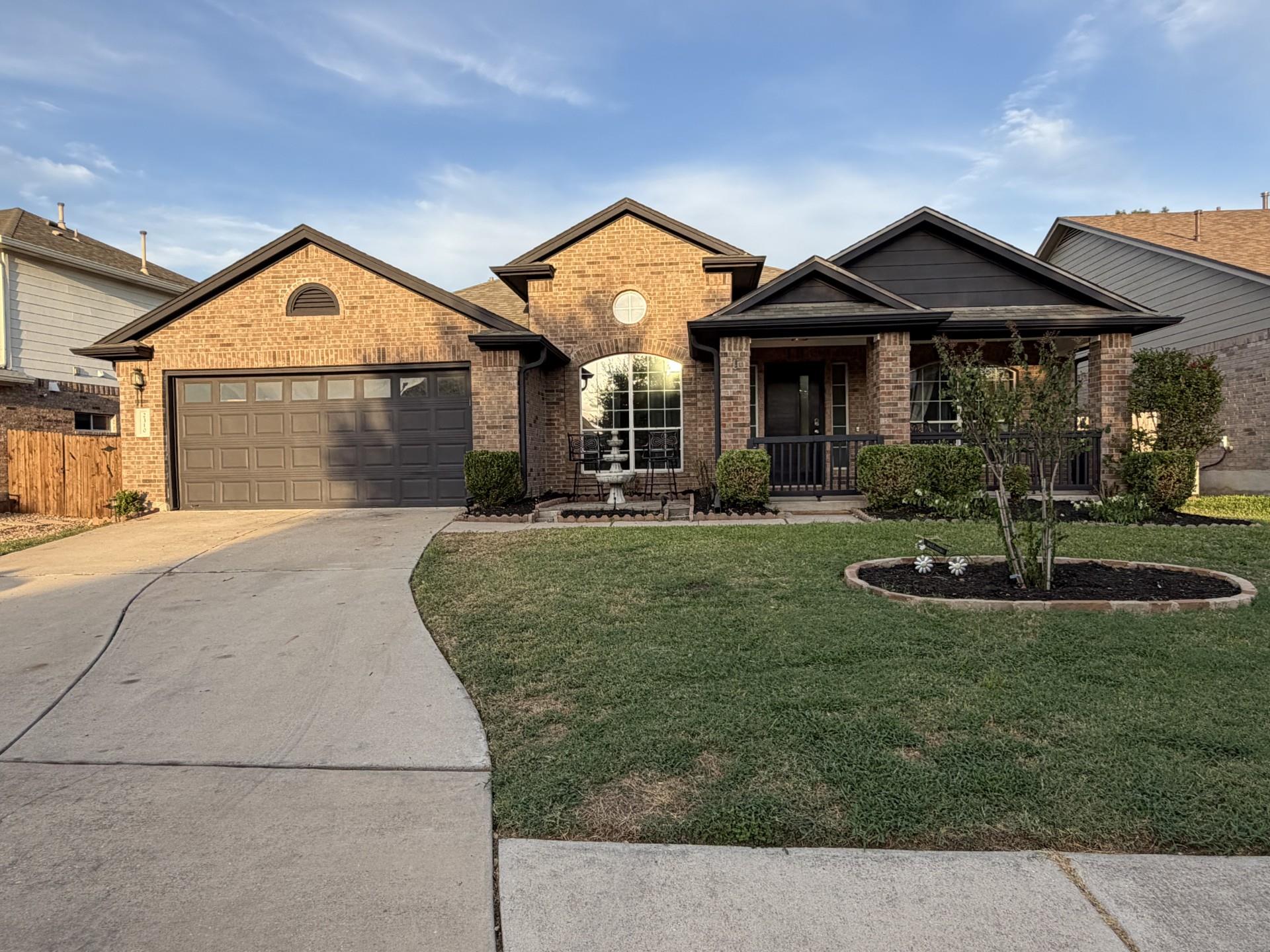 A classic brick facade welcomes you home with a w