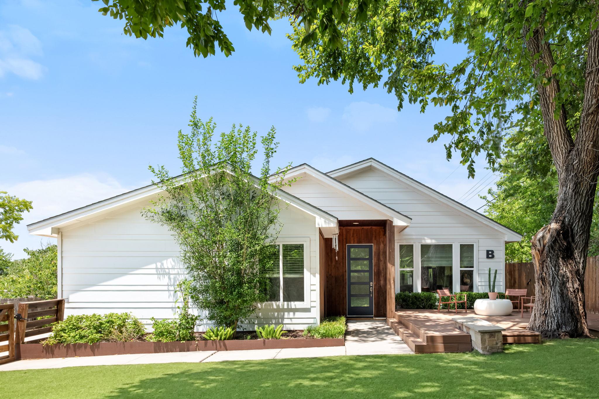 White siding with wood accents offers a modern fa