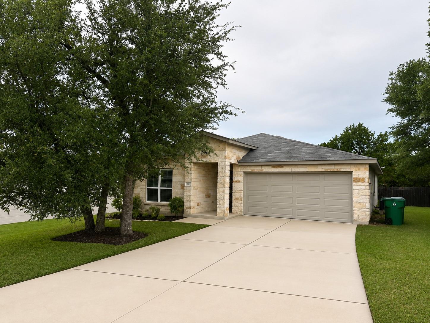 A well-maintained lawn and extended driveway gree