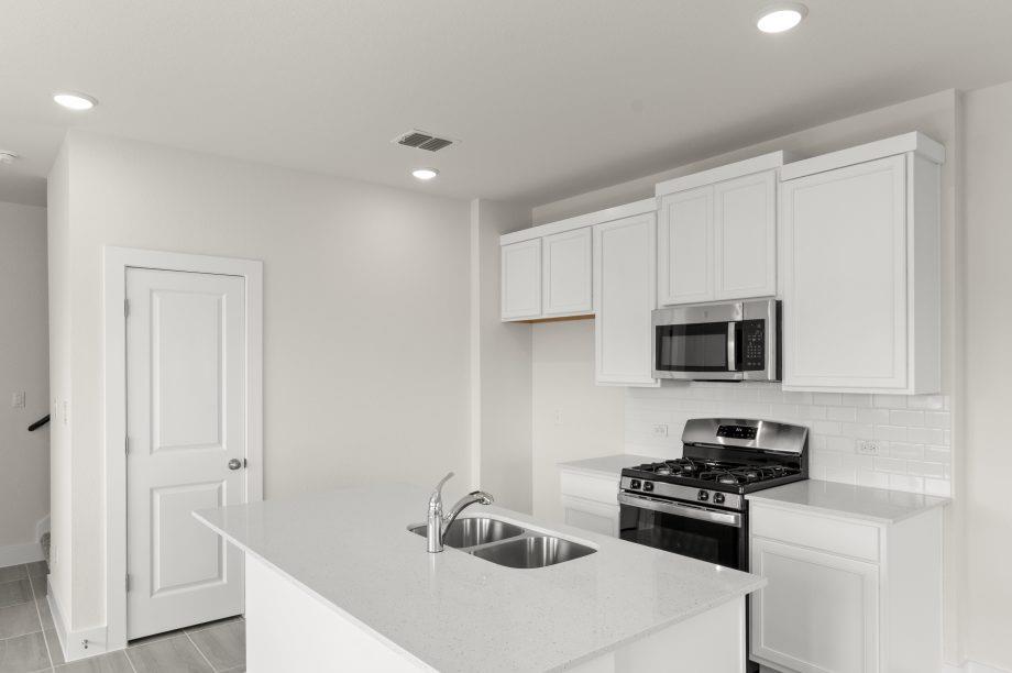 A well-appointed kitchen features a central islan