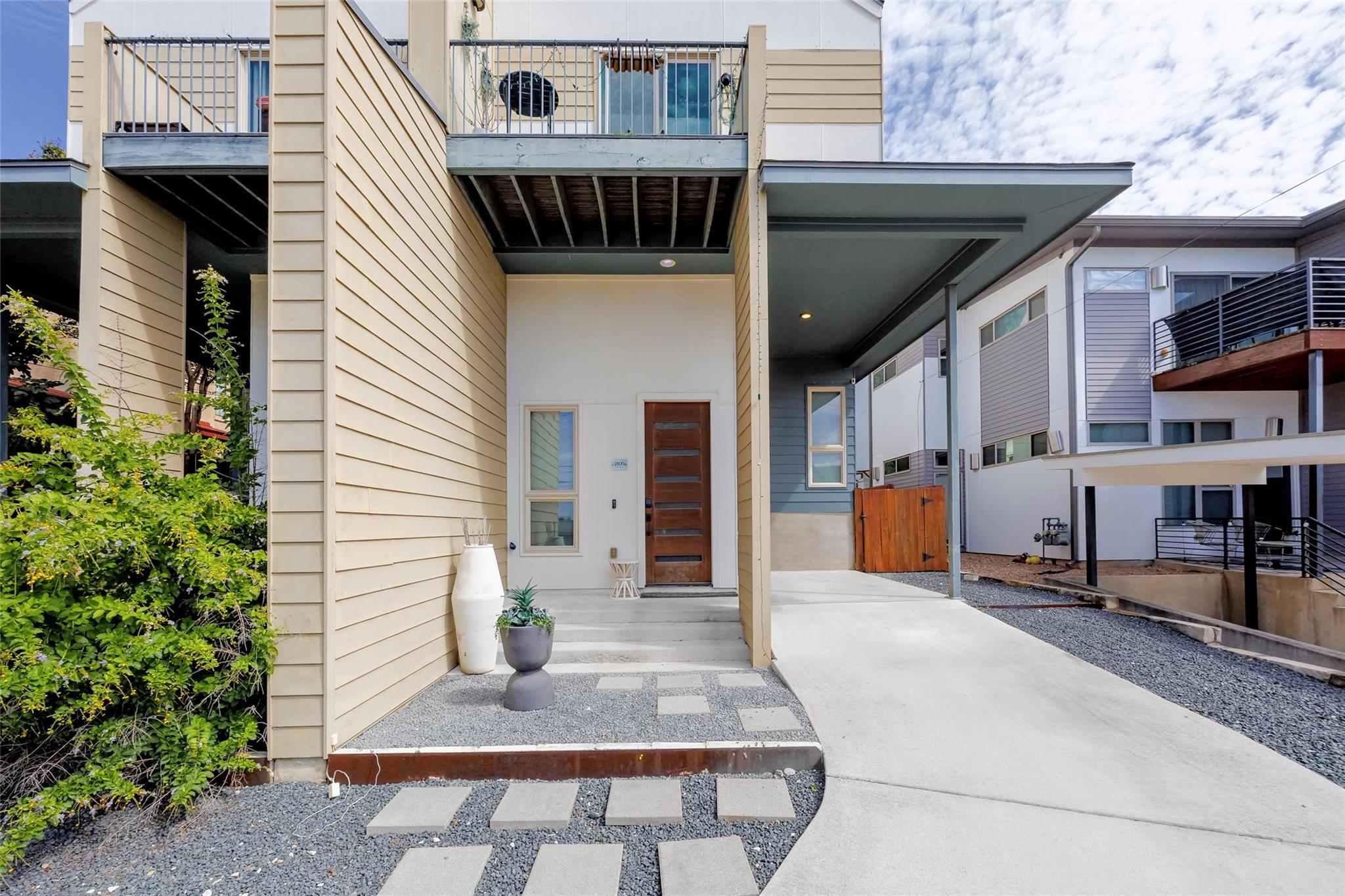 A contemporary exterior presents a covered entry,