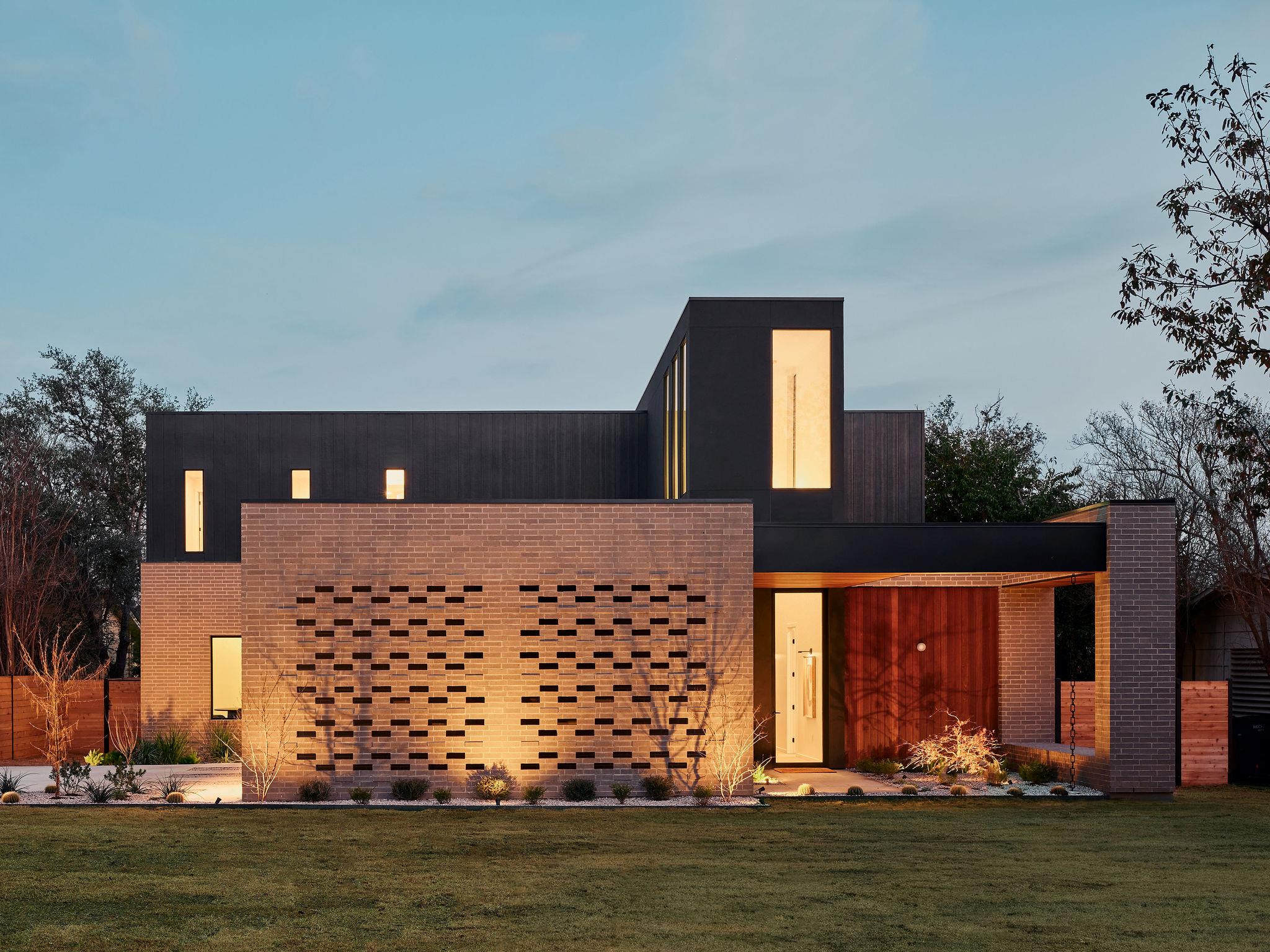 A striking modern facade with brick and dark sidi