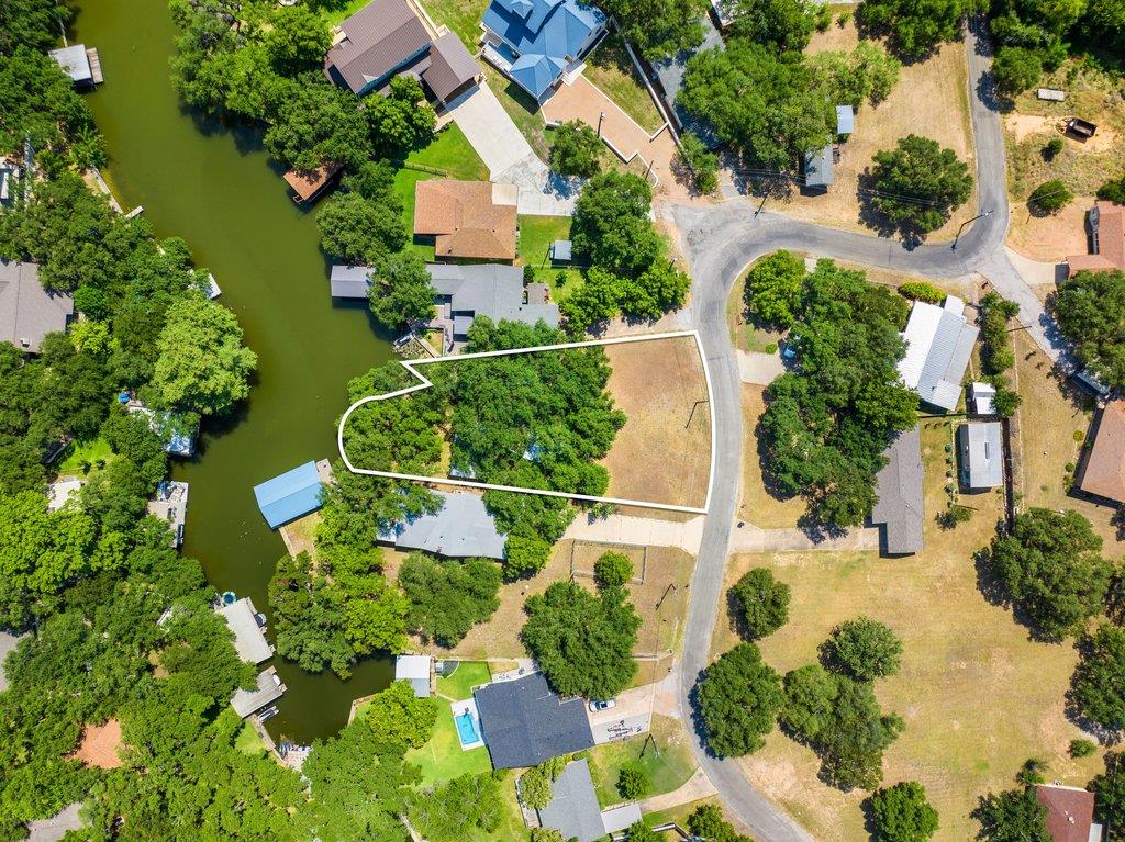 A prime waterfront lot with mature trees awaits y