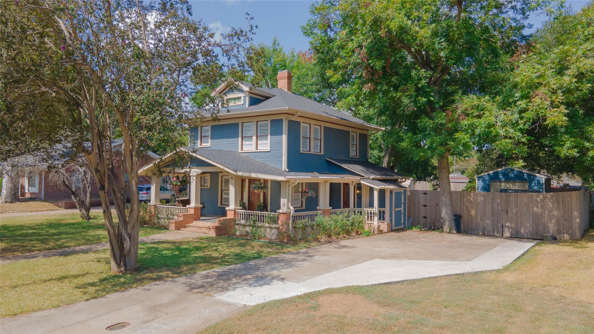 A classic blue two-story residence with a charmin