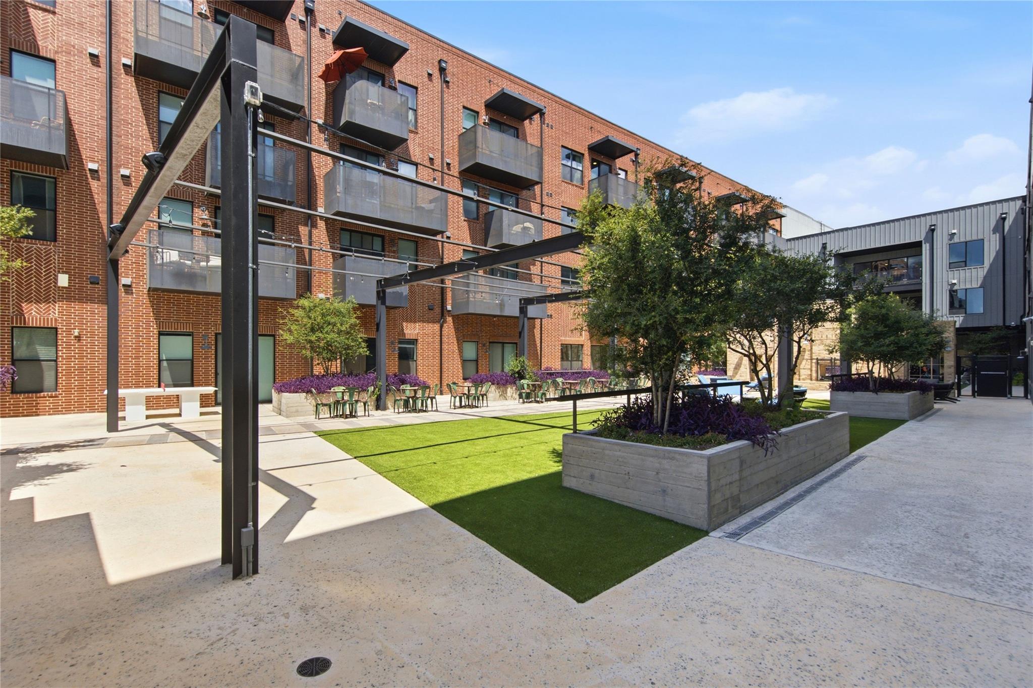 An inviting community courtyard provides verdant 
