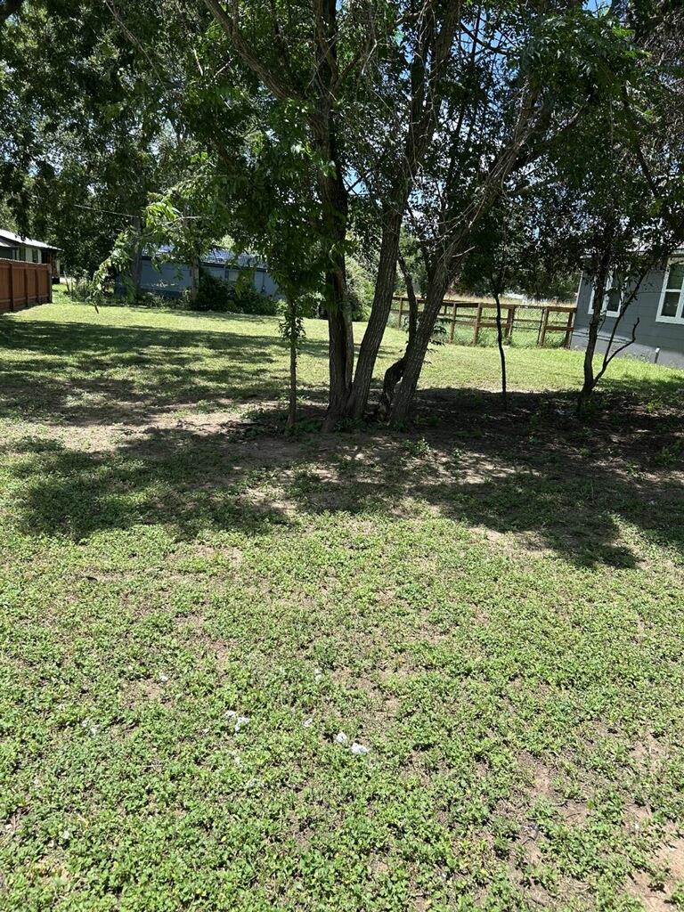 A generously sized yard, dotted with mature trees