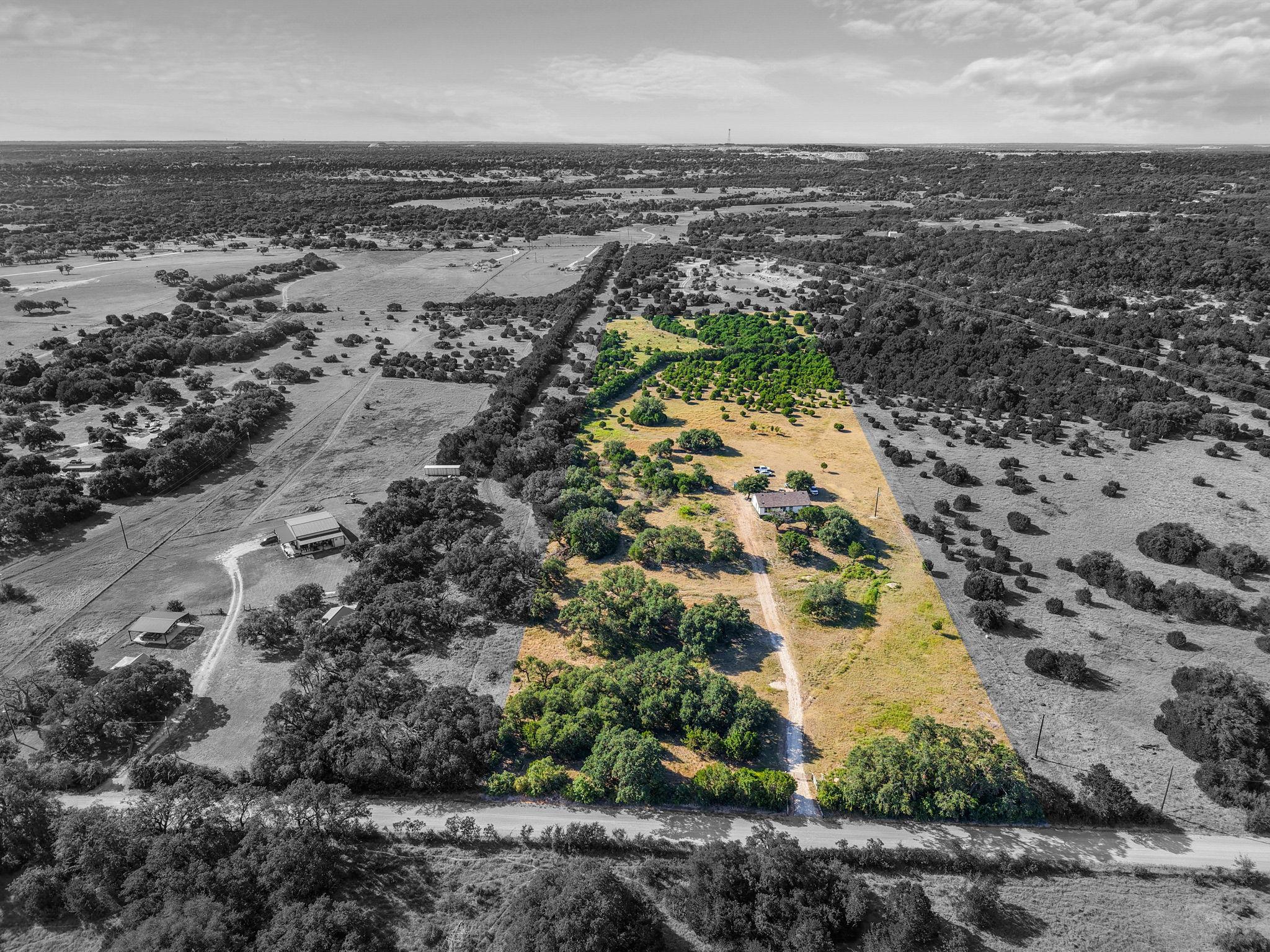 A long private driveway winds through the expansi