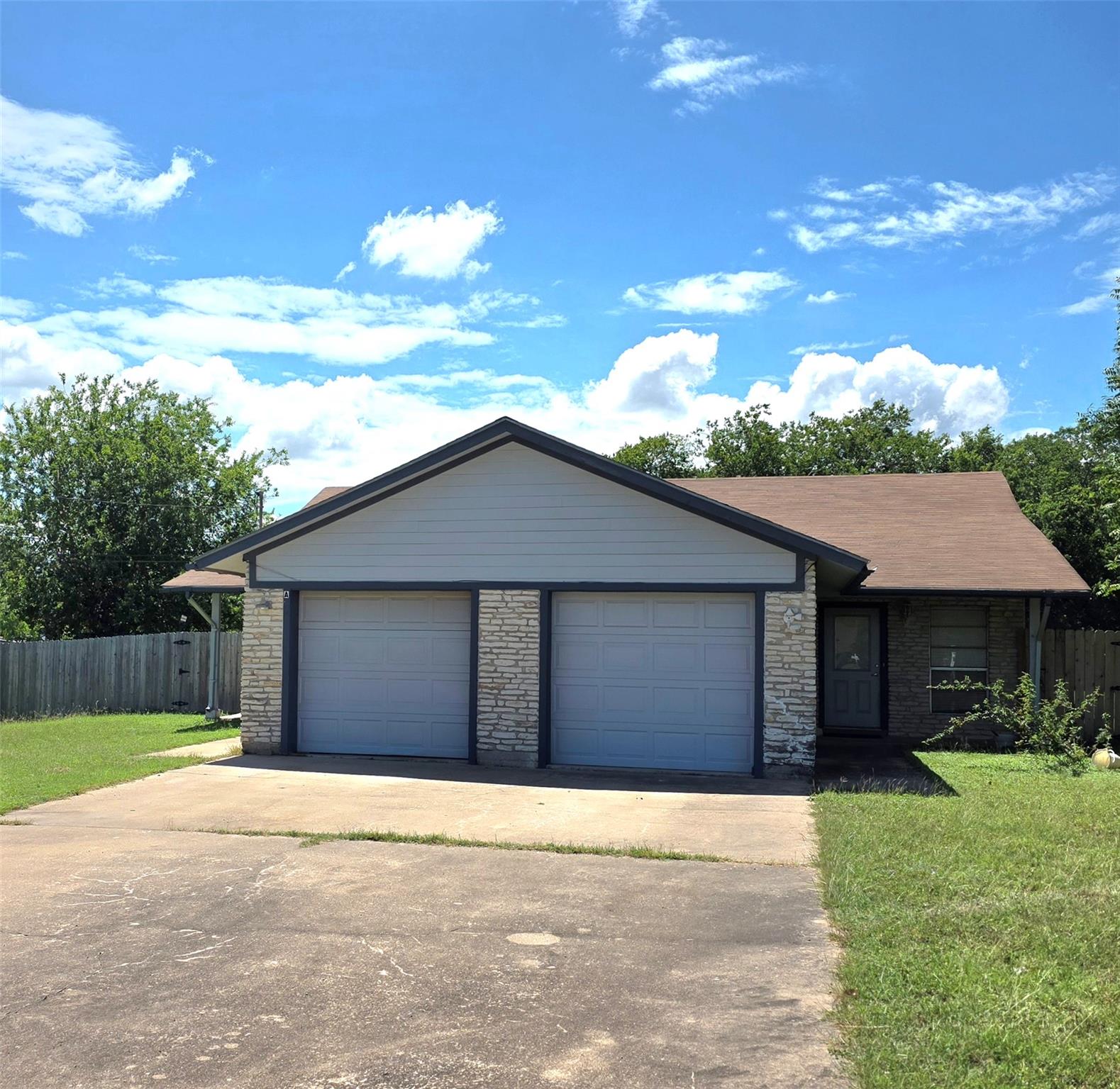 A well-maintained facade with a two-car garage an