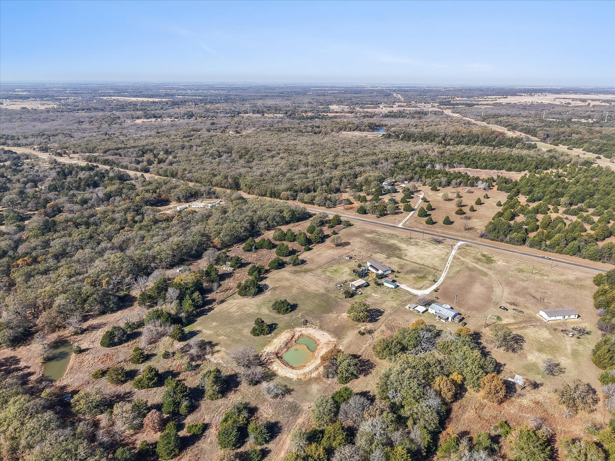 Vast acreage with scattered trees and multiple po