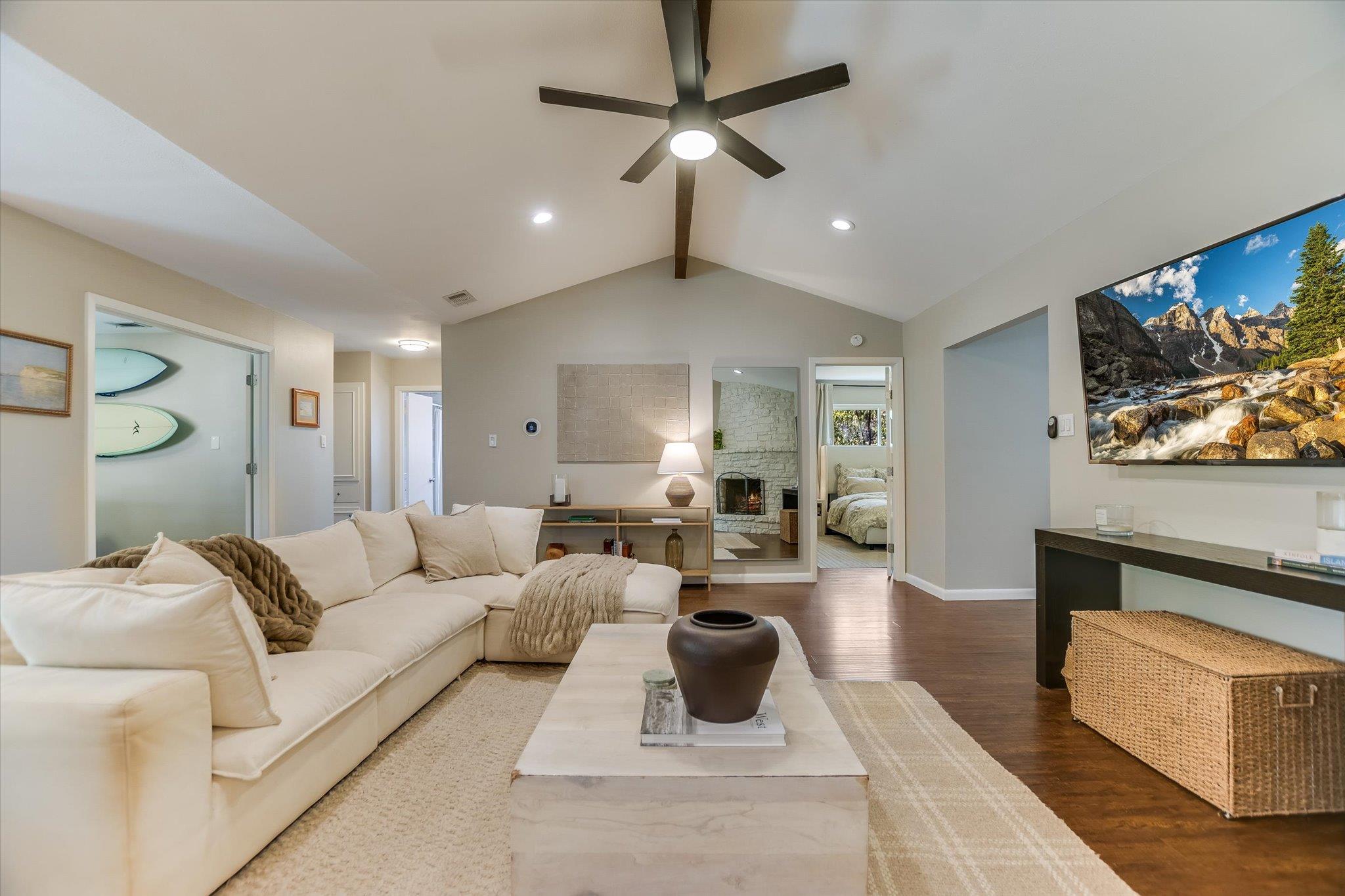 Rich wood flooring and vaulted ceilings define th