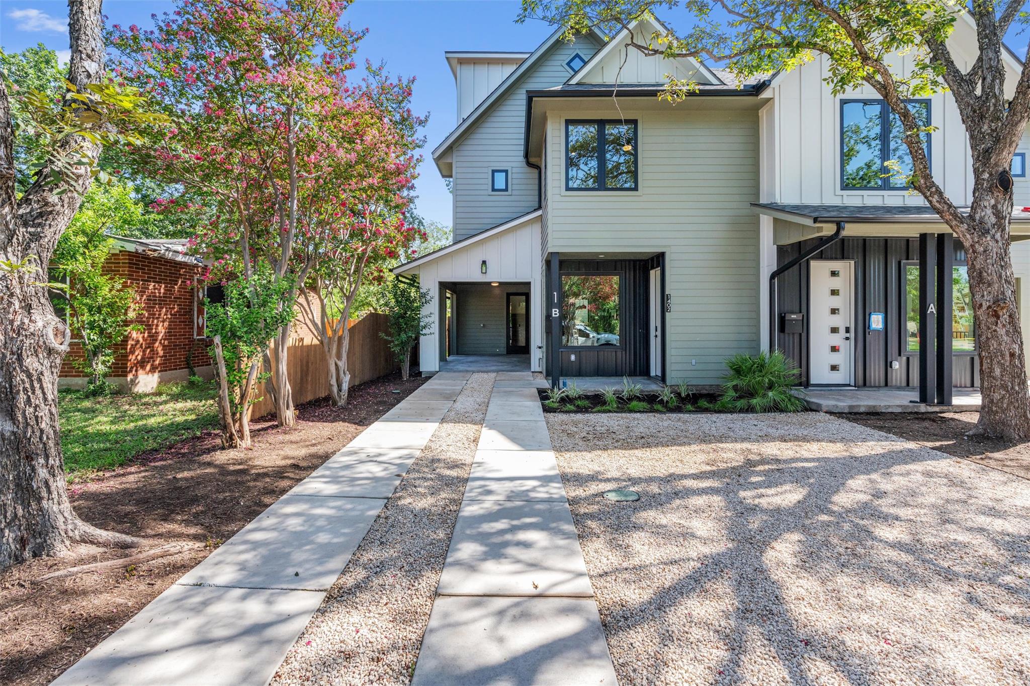 Modern townhome exterior with mixed siding and cl