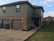 The inviting facade combines durable siding with 