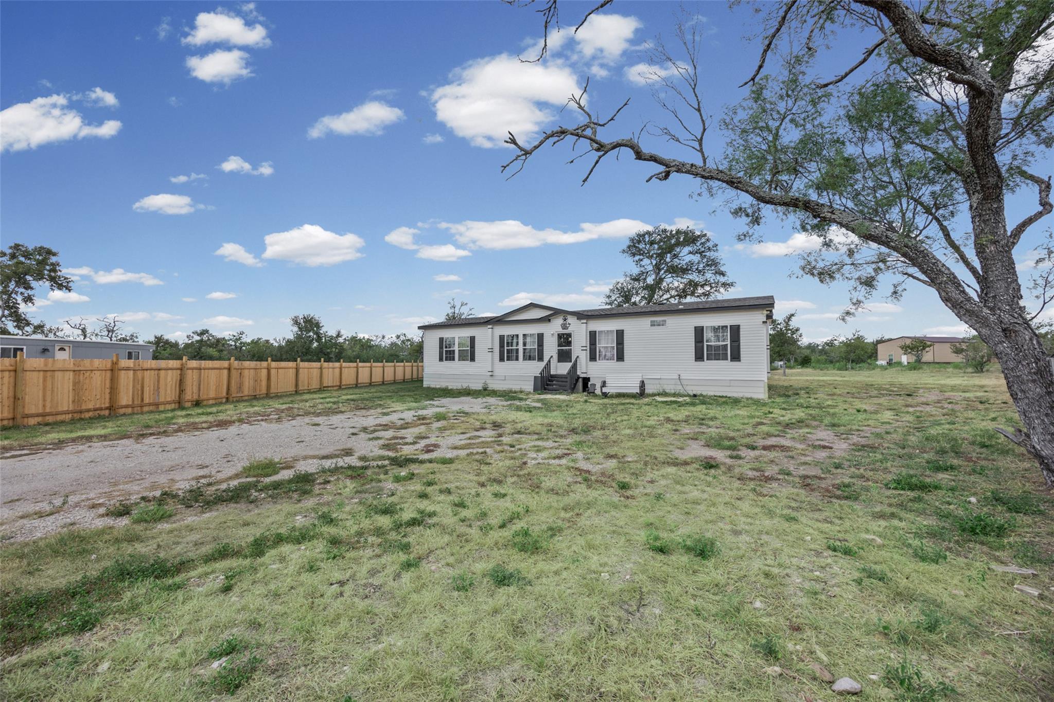 A manufactured home with a spacious yard and newl