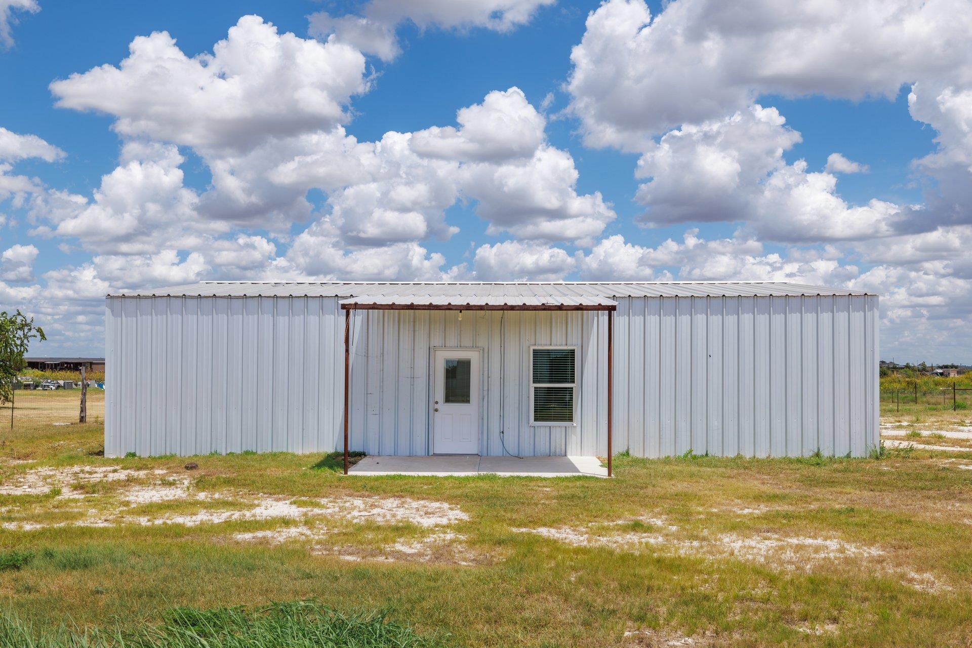 A utilitarian metal building offers a simple entr