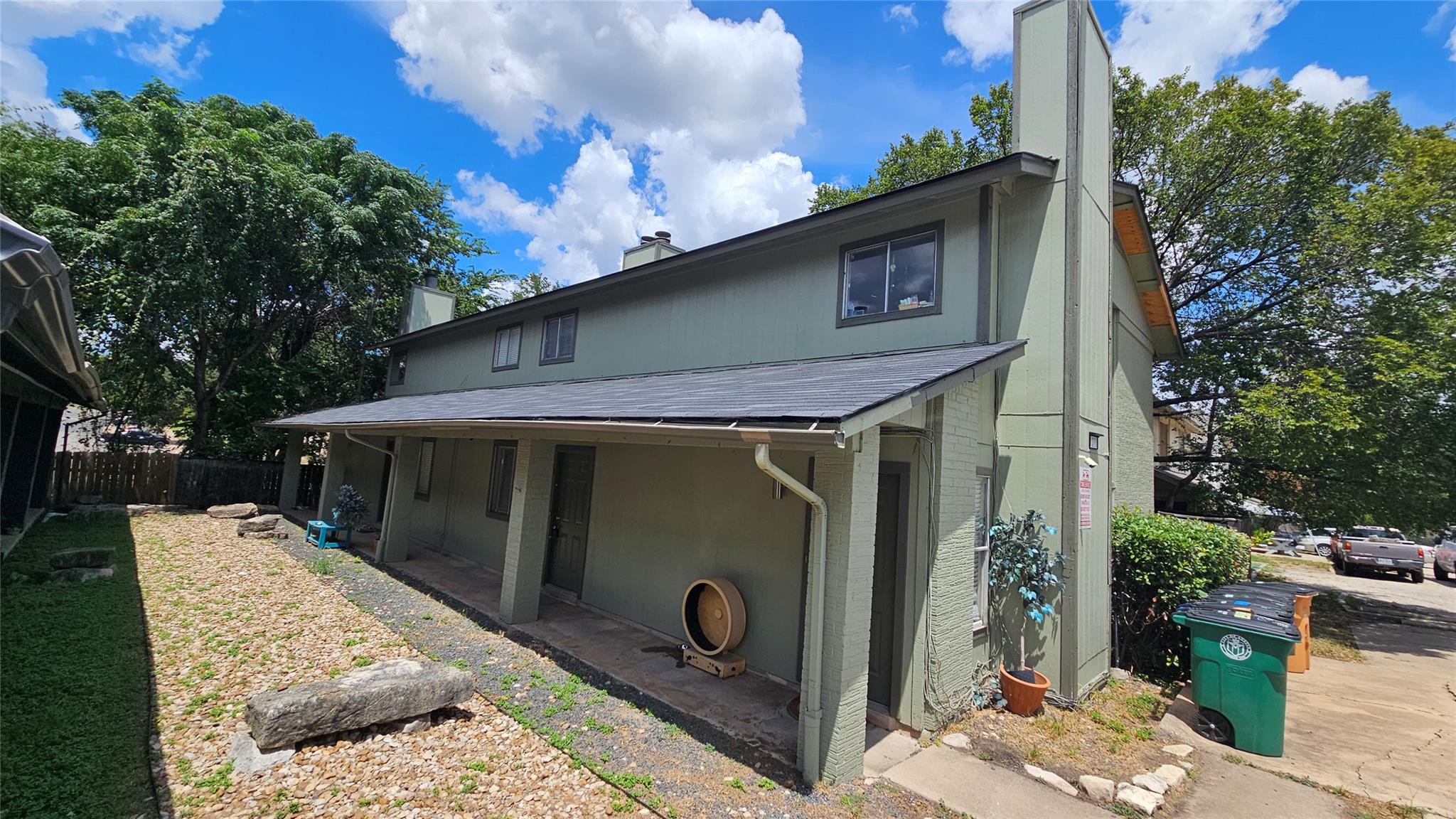 A classic two-story structure presents a covered 