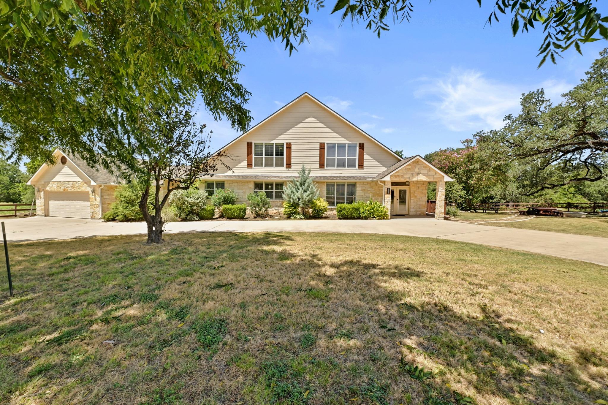 A circular driveway leads to this charming reside