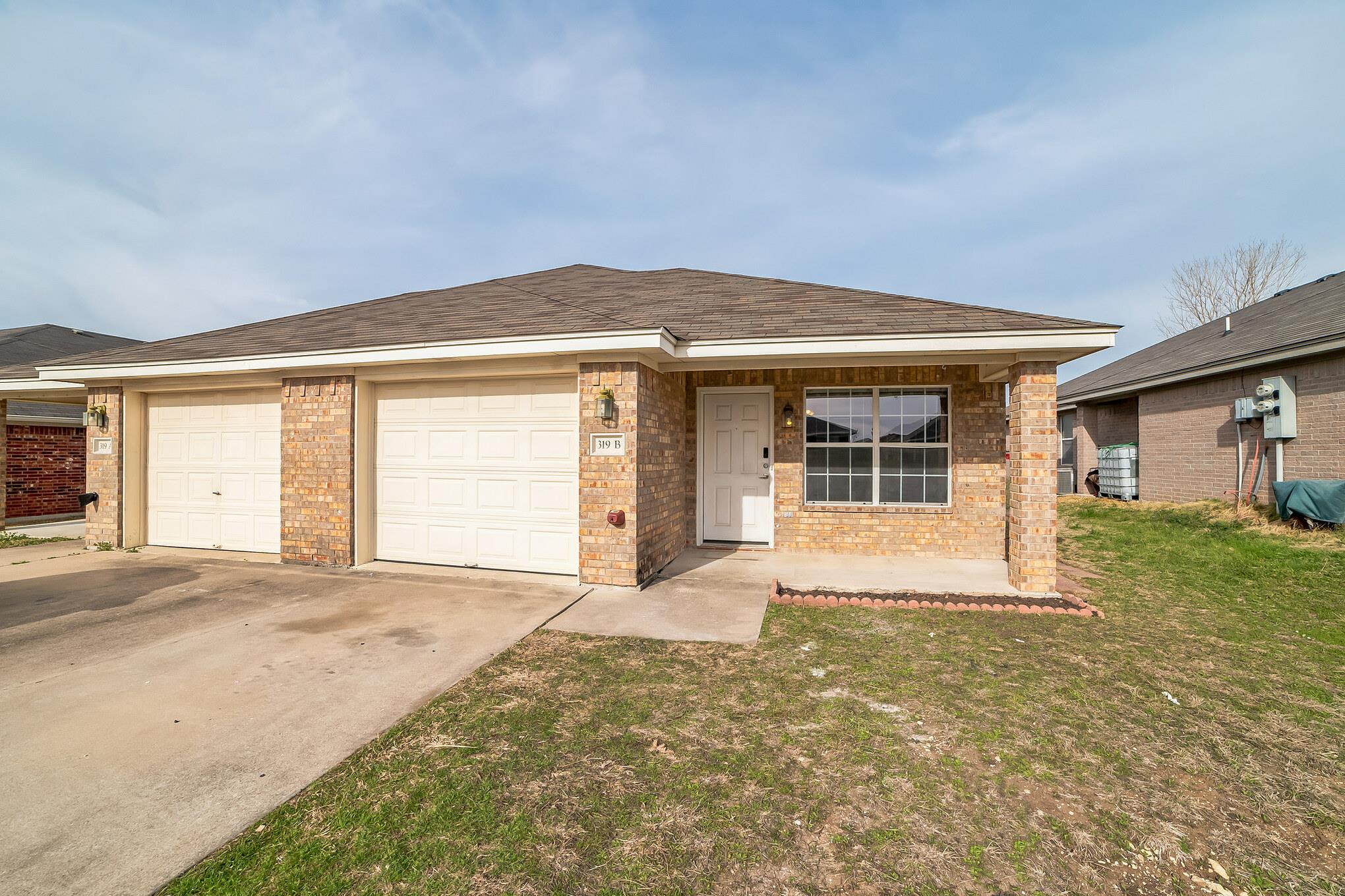 A classic brick exterior and attached garage make