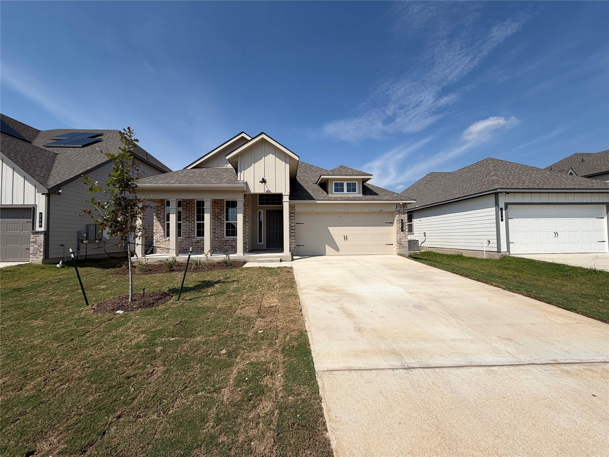 An inviting concrete driveway leads to a modern b
