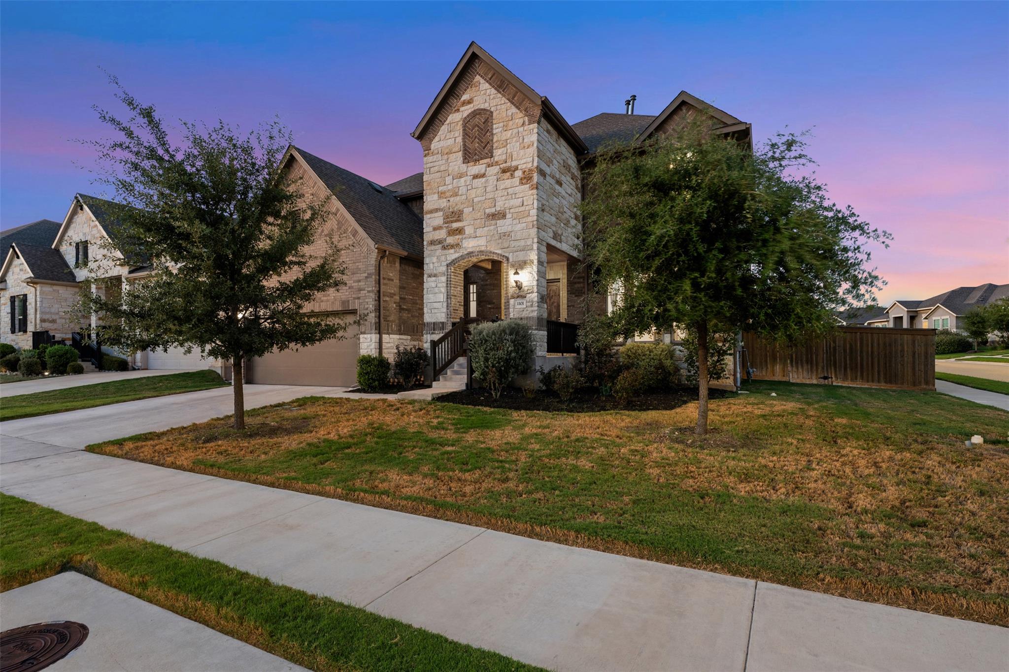 Multi-textured stone and brick siding defines thi