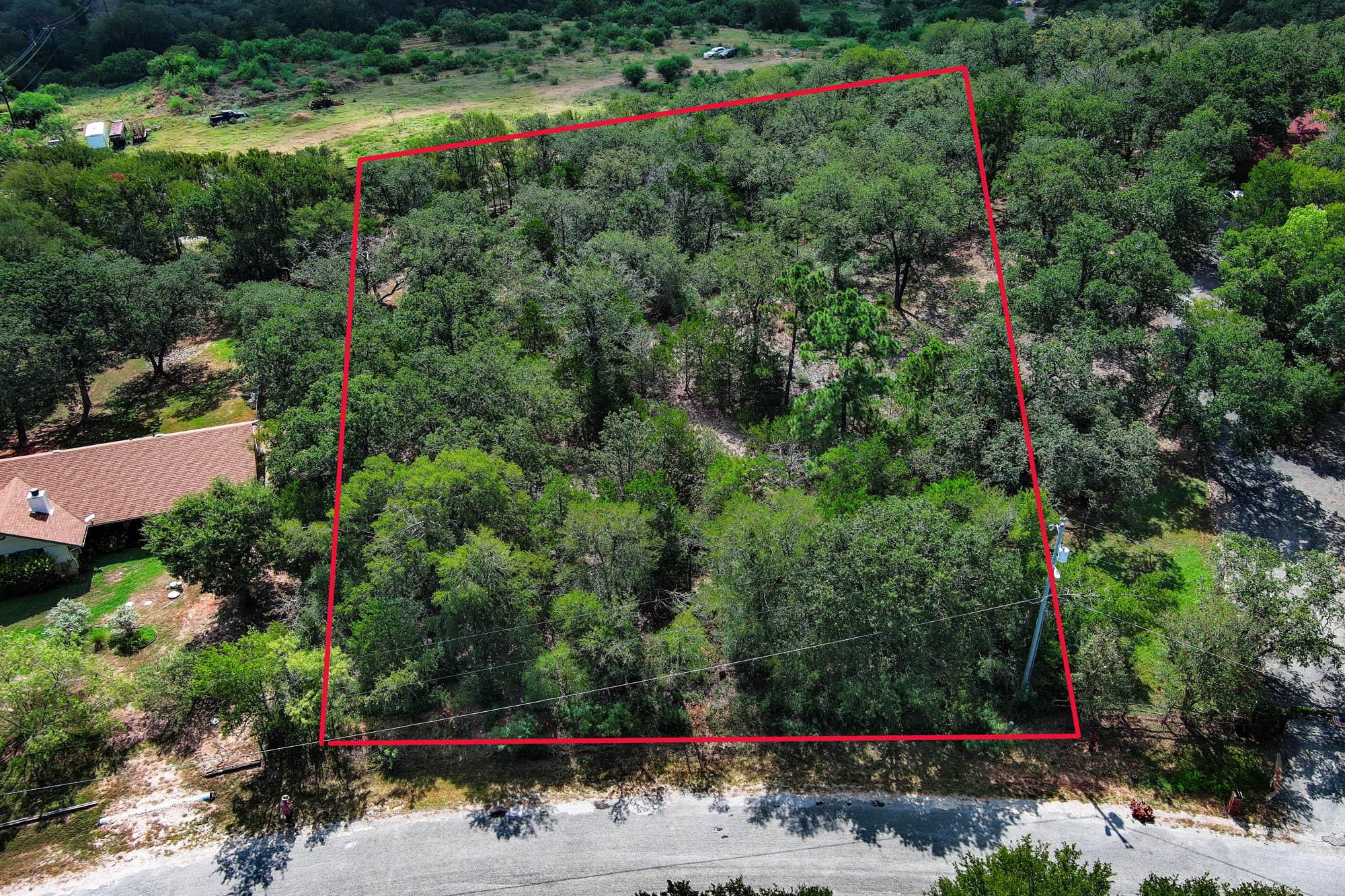 A verdant, tree-filled lot awaits your vision, bo