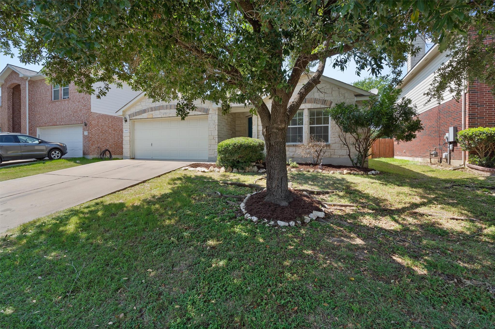 A well-maintained lawn and mature tree enhance th